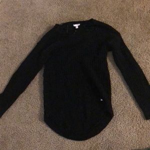 A black knitted sweater. Long sleeve.